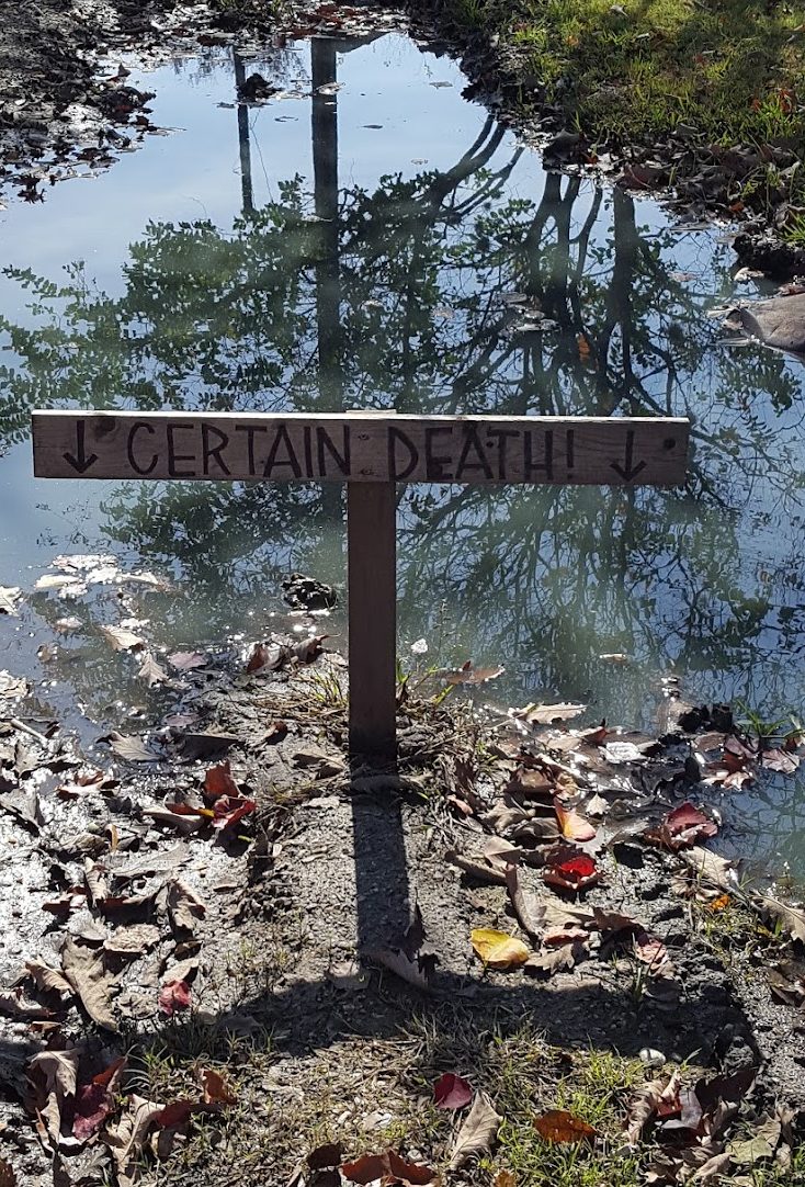 comical sign over standing water in montrose